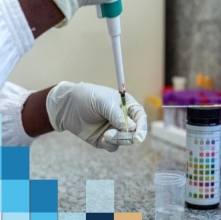 health worker filling vial in a lab
