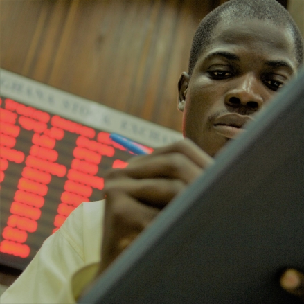  A financial trader in Ghana checks stock and commodity prices