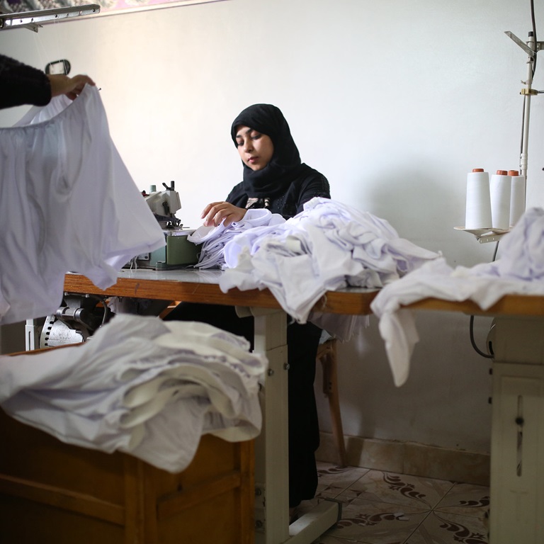 Female employee at Rich Factory sewing mens underwear.