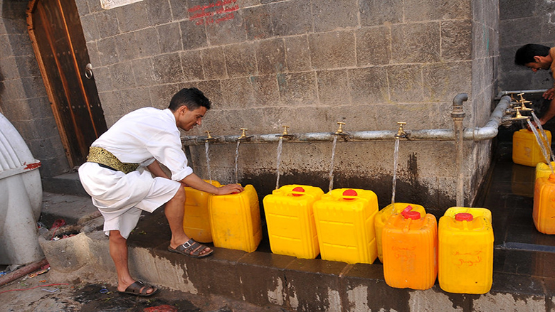 An image of a man collecting water
