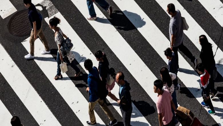 Aerial view of people crossing a the street