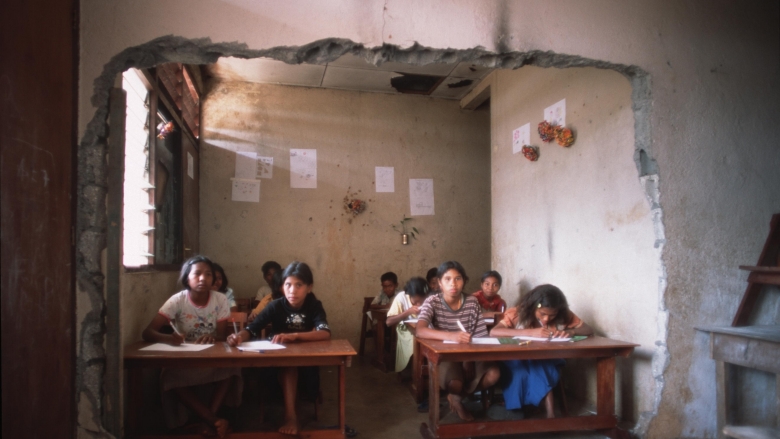 Girls in a war torn classroom