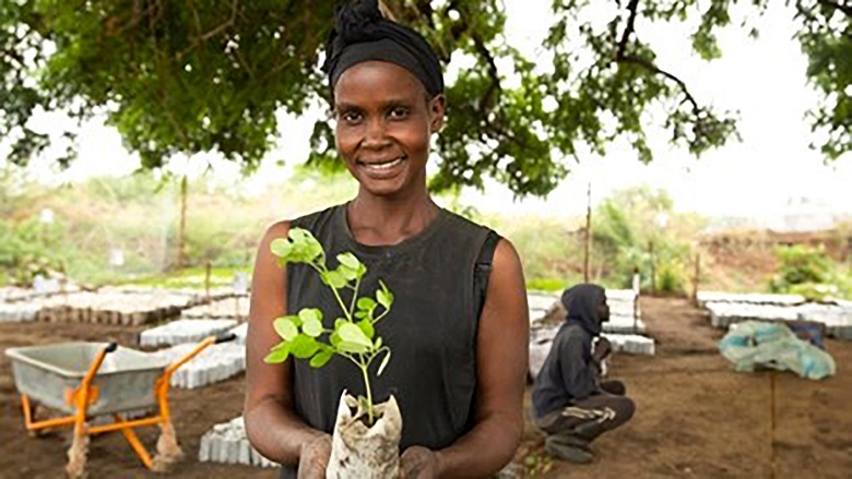 woman holding plant in south sudan