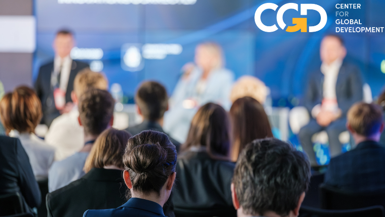 People seated while panelists are speaking at an event