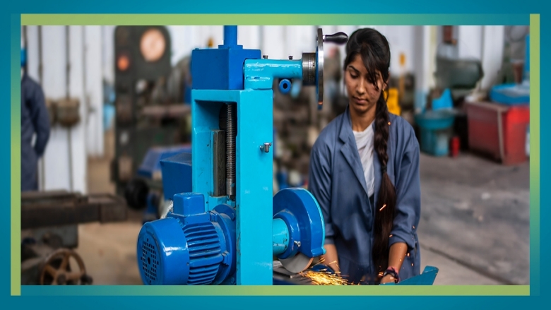 Female technician operating on a grinding machine 