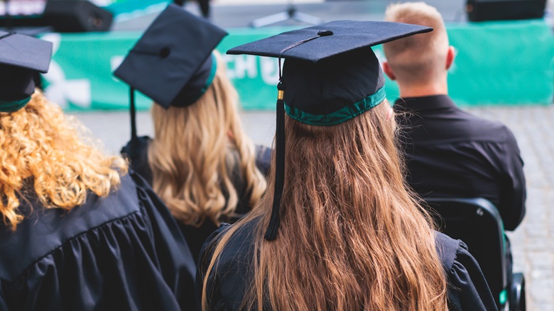 University students at graduation in their caps and gowns