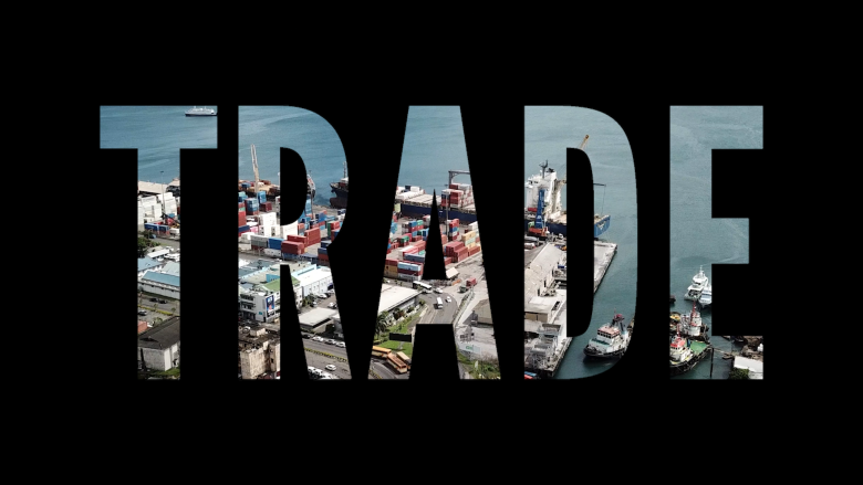 The word Trade superimposed over a sea port